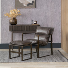 Lade das Bild in den Galerie-Viewer, Modern brown leather chair and ottoman in a room with a decorative table and wall art.