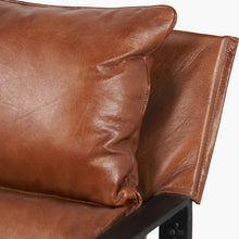 Lade das Bild in den Galerie-Viewer, Close-up of a brown leather armchair with a pillow on a white background