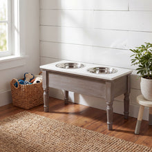 Carica l'immagine nel visualizzatore di Gallery, Pet feeding station table in grey wash wood with two stainless steel bowls, perfect for furry friends.