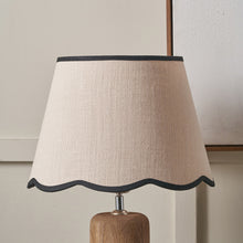 Lade das Bild in den Galerie-Viewer, natural coloured lamp shade with a scalloped lower edge and with black binding on a wooden base