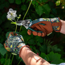 Charger l'image dans la galerie, Gardening gloves in woodland wonders design being used to trim a flower with pruning shears.
