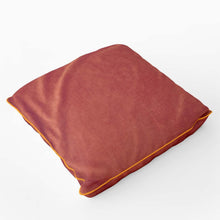 Load image into Gallery viewer, Velvet velour cushion in burnt orange with coordinating piping, handmade in the UK, perfect for adding luxury to any space.
