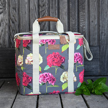 Carica l'immagine nel visualizzatore di Gallery, cooler bag in a vibrant hydrangea print with a dark stone background with carry handles and a shoulder strap