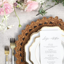 Carica l'immagine nel visualizzatore di Gallery, Placemat featuring Balinese braided rattan charger plate underneath elegant dinnerware and floral arrangement.