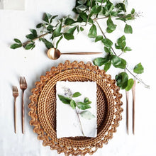 Carica l'immagine nel visualizzatore di Gallery, Placemat featuring a Balinese braided rattan charger plate with natural elements on a dining table.