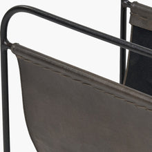 Charger l'image dans la galerie, Close-up of a stylish magazine rack in peppercorn leather on a steel frame, showcasing its handcrafted design.
