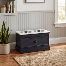Lade das Bild in den Galerie-Viewer, Pet feeding station table in black wood with stainless steel bowls and storage drawer.
