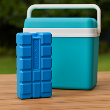 Load image into Gallery viewer, Ice blocks next to a teal cooler, showcasing the reusable ice blocks for keeping food and drinks cool.
