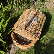 Load image into Gallery viewer, Boat shaped picnic basket made from willow in a green garden background
