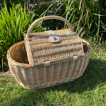 Load image into Gallery viewer, Boat shaped picnic basket made from willow in a green garden background
