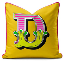 Charger l'image dans la galerie, Letter cushion in vibrant yellow with a playful 'D' design, featuring bold carnival-style fonts.
