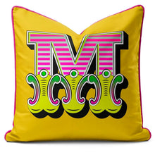 Charger l'image dans la galerie, Letter cushion featuring a vibrant yellow carnival letter 'M' with bold colors and luxurious velvet fabric.
