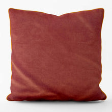 Load image into Gallery viewer, Velvet velour cushion in burnt orange with coordinating piping, showcasing its luxurious texture and handmade quality.

