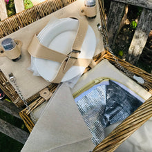 Carica l'immagine nel visualizzatore di Gallery, Deluxe picnic hamper interior with porcelain plates, wine glasses, and insulated compartment for food.
