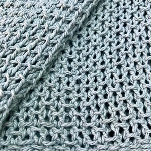 Open knit tasseled throw